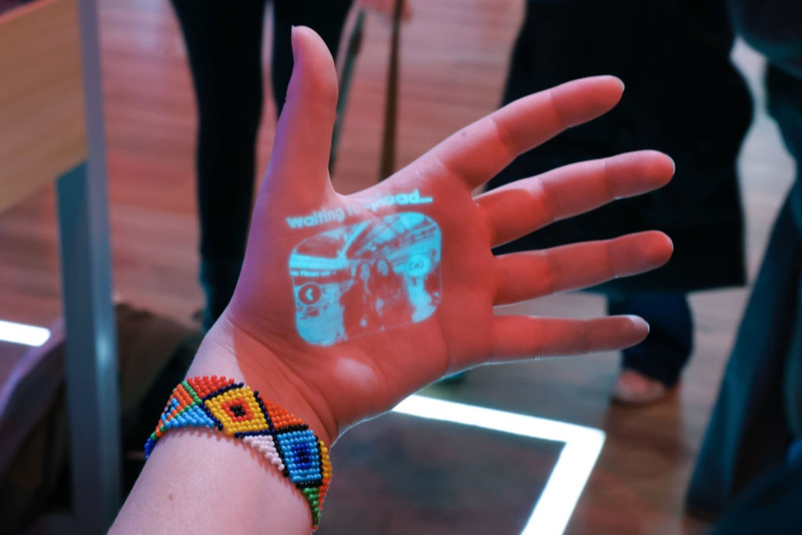 An employee demonstrates the laser ink display projection of a wearable Humane Inc. AI pin on the opening day of the Mobile World Congress (MWC) at the Fira de Barcelona venue in Barcelona, Spain, on Monday, Feb. 26, 2024.