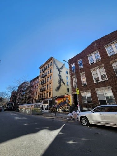 Manhattan street scene during afternoon showing cars and buildings.