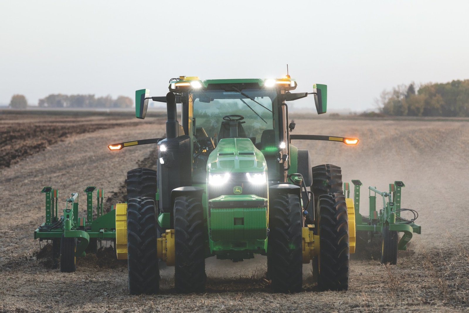 Green John Deere tractor facing front.